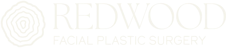 Redwood Credit Union white logo with circular tree ring symbol